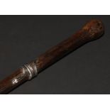 An early 20th century silver coloured metal mounted palmwood walking stick, the cane entwined by a