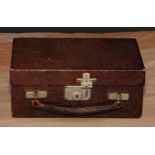A mid-20th century crocodile leather travelling jewellery box, hinged cover enclosing a fitted tray,