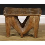 Tribal Art - a Nupe stool, the rectangular top carved with geometric motifs, 30cm high, 48cm wide,