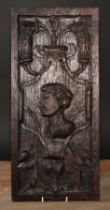 A 16th/17th century oak Romayne panel, carved in relief with a portrait bust, scrolls and strapwork,