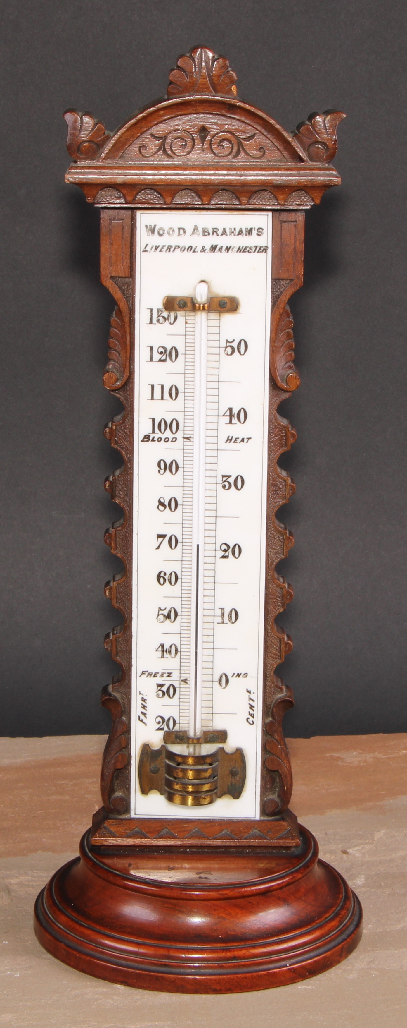 A large and unusual Victorian walnut table top thermometer, the opaque glass register inscribed Wood