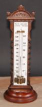 A large and unusual Victorian walnut table top thermometer, the opaque glass register inscribed Wood