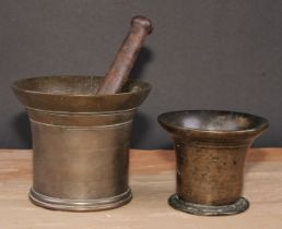 An 18th century bronze pestle and mortar, flared rim, 12.5cm cm high, c.1760; another, smaller (2)