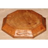 Martin Dutton, Lizardman of Huby, Yorkshire - an oak octagonal teapot stand, adzed overall, carved