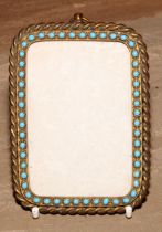 A 19th century gilt brass rounded rectangular pendant picture or photograph frame, the rope-twist