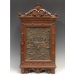 A 19th century Continental oak wall hanging hall cabinet, in the Renaissance Revival taste, shaped