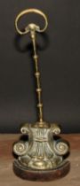 A 19th century brass and cast iron door stop or Porter, cast with lotus and scrolls, posted