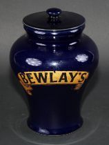 A stoneware Bewlays inverted baluster tobacco or snuff jar and cover labeled in gilt on a cobalt