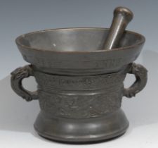 A Dutch bronze pestle and mortar, cast with birds and scrolling foliage, inscribed beneath the rim