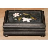 An Italian pietra dura and ebonised casket, hinged cover set with a panel inlaid with a spray of