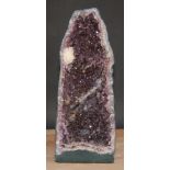 Natural History - Geology - a large amethyst geode 'grotto', bisected to display matrix, 50cm high