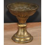 A Middle Eastern brass pedestal stand, profusely chased and engraved in the Islamic taste with