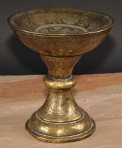 A Middle Eastern brass pedestal stand, profusely chased and engraved in the Islamic taste with