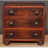 An early Victorian rosewood miniature chest of drawers, flush top above three long graduated