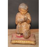 A Continental carving, in the Baroque taste as a young figure kneeling in prayer, giltwood and gesso