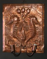 An Arts and Crafts copper wall sconce, repousse chased in the manner of Newlyn with a pair of