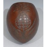 A 19th century coconut cup, carved with a pineapple, coconut trees and leaves, 12cm high