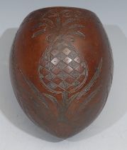 A 19th century coconut cup, carved with a pineapple, coconut trees and leaves, 12cm high