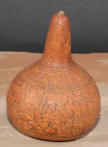 A South American gourd, engraved with densely congregated figures, 13cm high