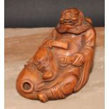 A Chinese bamboo figure, carved as an elder seated on a gourd, 14.5cm high