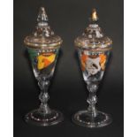 A pair of Continental glass goblets and covers, each decorated in polychrome enamels with