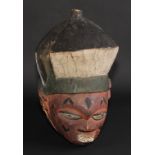 Tribal Art - a Yoruba mask, painted in polychrome, 37cm long, Nigeria