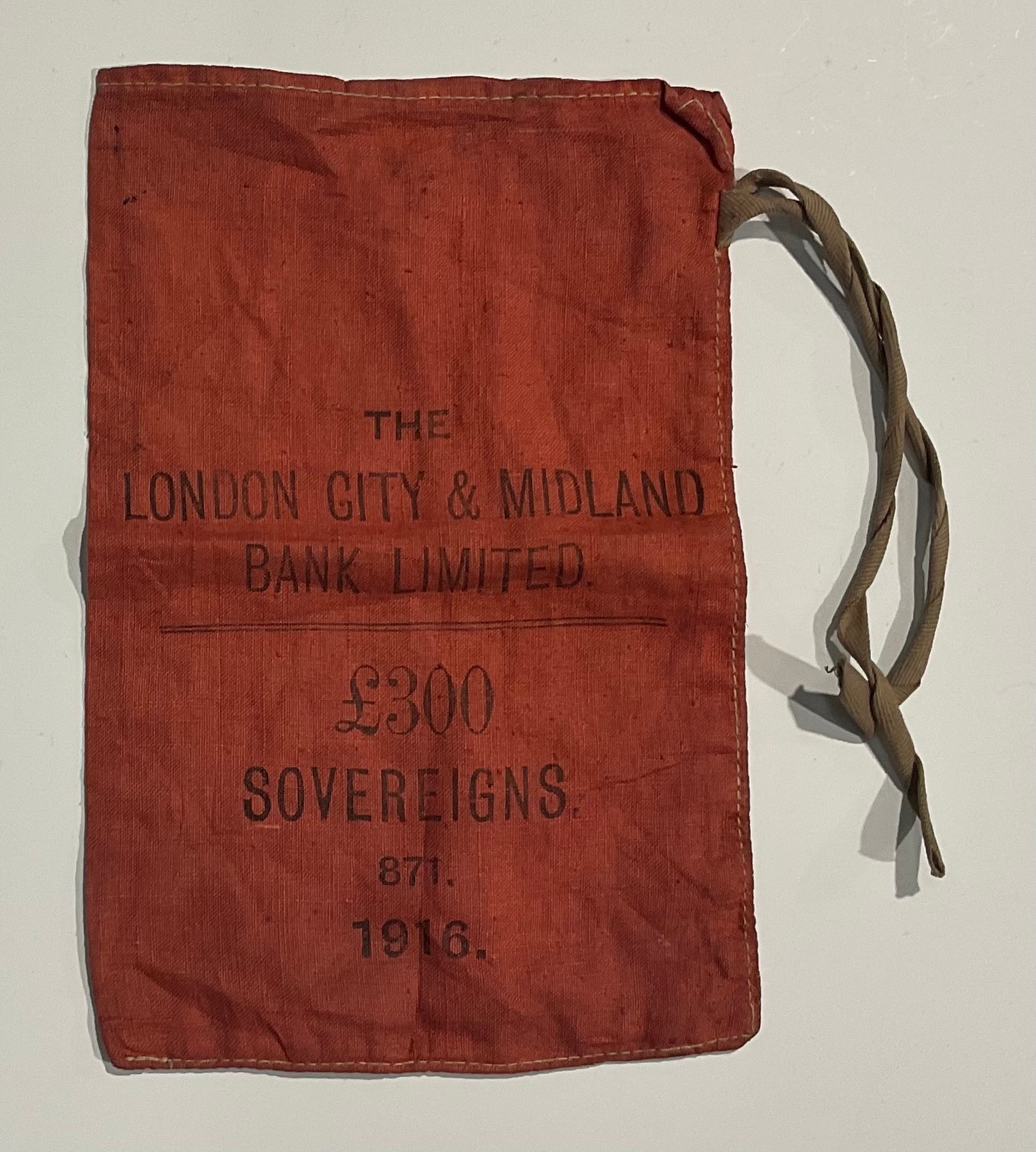 An early 20th century red canvas sovereign bag, with two tie strings, printed in black, The London - Image 2 of 3