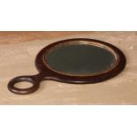 A George III mahogany hand mirror, outlined with boxwood and ebony stringing, 20.5cm long, early