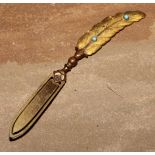 A late 19th century gilt brass novelty bookmark, as a feather quill, set with turquoise cabochons,