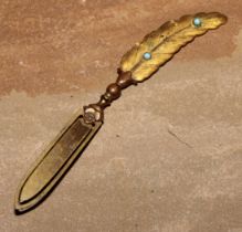 A late 19th century gilt brass novelty bookmark, as a feather quill, set with turquoise cabochons,