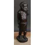 Slavery - a West African tribal hardwood carving, of a slave in chains, 39cm high