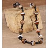 A 19th century banded agate bead necklace, 25.5cm drop