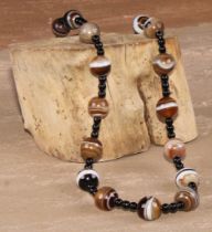 A 19th century banded agate bead necklace, 25.5cm drop