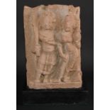 Antiquities - an Indian pink sandstone stele, carved in bold relief with deities, 32cm high, c.