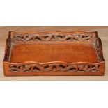A 19th century mahogany letter tray, the shaped gallery pierced and carved with scrolling