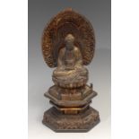 A Chinese lacquer shrine figure, of Buddha, seated within a lotus, hexagonal base, 26.5cm high