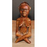 Tribal Art - an African female figure, seated, cross-legged, 15cm high