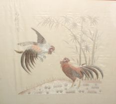 A Chinese needlework picture, worked in silvered, gilt and coloured threads with a cockfighting