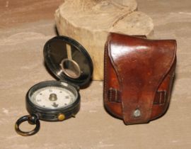 An early 20th century brass compass, probably military, 8cm over loop, leather case