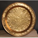 A brass alms dish, chased with scrolling leaves, 45cm diam