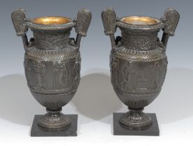 A pair of 19th century Grand Tour bronze urns, after Ancient Greek volute kraters, cast in bas