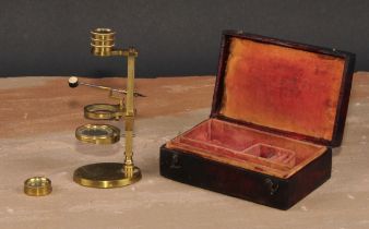 A George III lacquered brass travelling pocket microscope, square pillar, concave mirror, oval base,