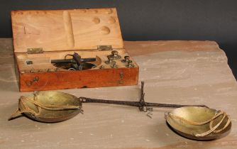 A set of early 20th century iron and brass balance scales, the weights to 200 grammes, the beam 25cm