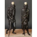 A pair of French spelter figural caricature candlesticks, possibly after Emile Guillemin (1841 -