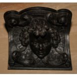 A 19th century oak corbel wall bracket, boldly carved with a putto mask, 21.5cm wide
