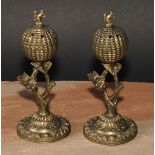 A pair of post-Regency gilt bronze cassolettes, each crested by a squirrel, fruiting vine
