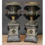 A pair of 19th century dark patinated bronze half fluted campana mantel urns, beaded borders,