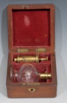 A Victorian gilded brass and clear glass breast pump by S Maw & Son, Thompson Place, London, red