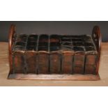 A late 19th/early 20th century novelty oak cigar box, as a folding book rack with seven leather