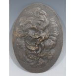 A Continental brown patinated bronze oval plaque, cast in relief with an allegory of love,